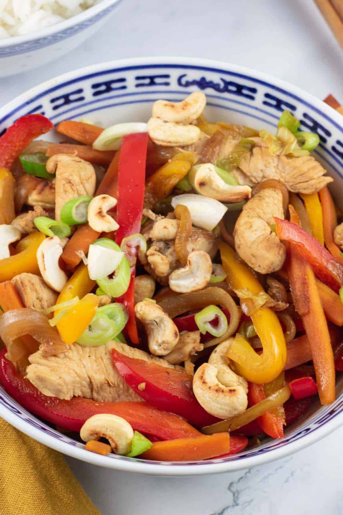 Close up of chicken and cashew nut stir-fry in an oriental bowl.