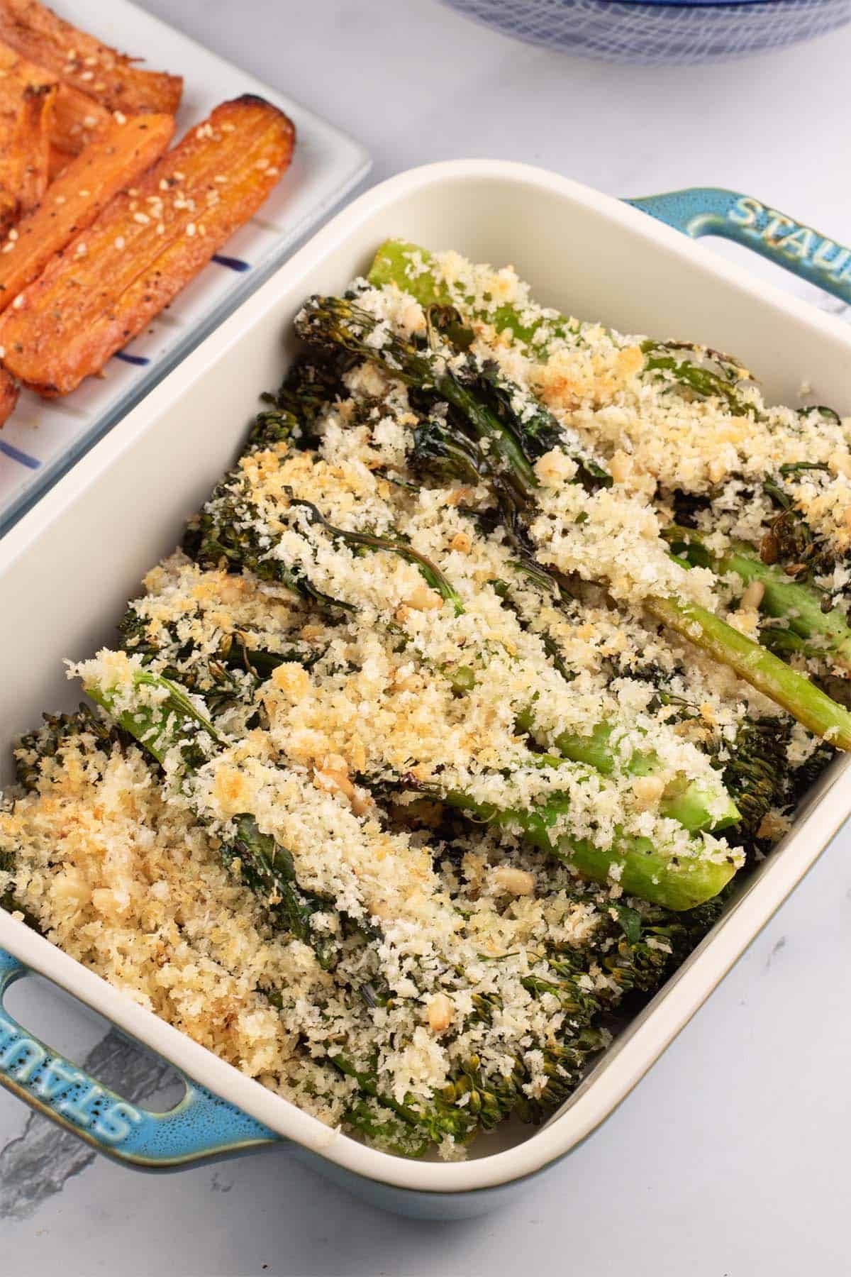 Roast tenderstem broccoli with parmesan and pine nut crumb in a Staub dish with za'atar carrots on the side.