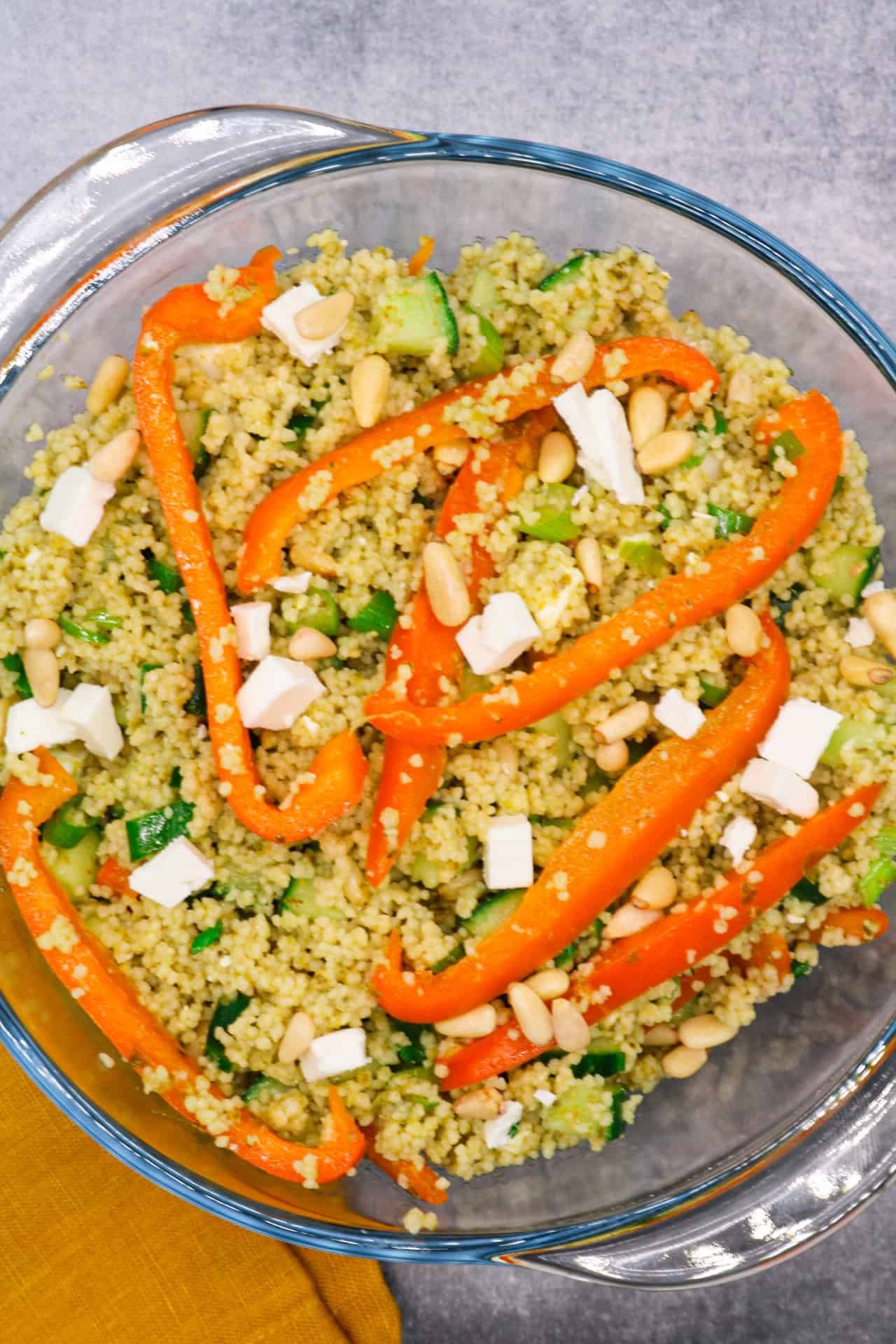 Couscous salad with feta in clear bowl