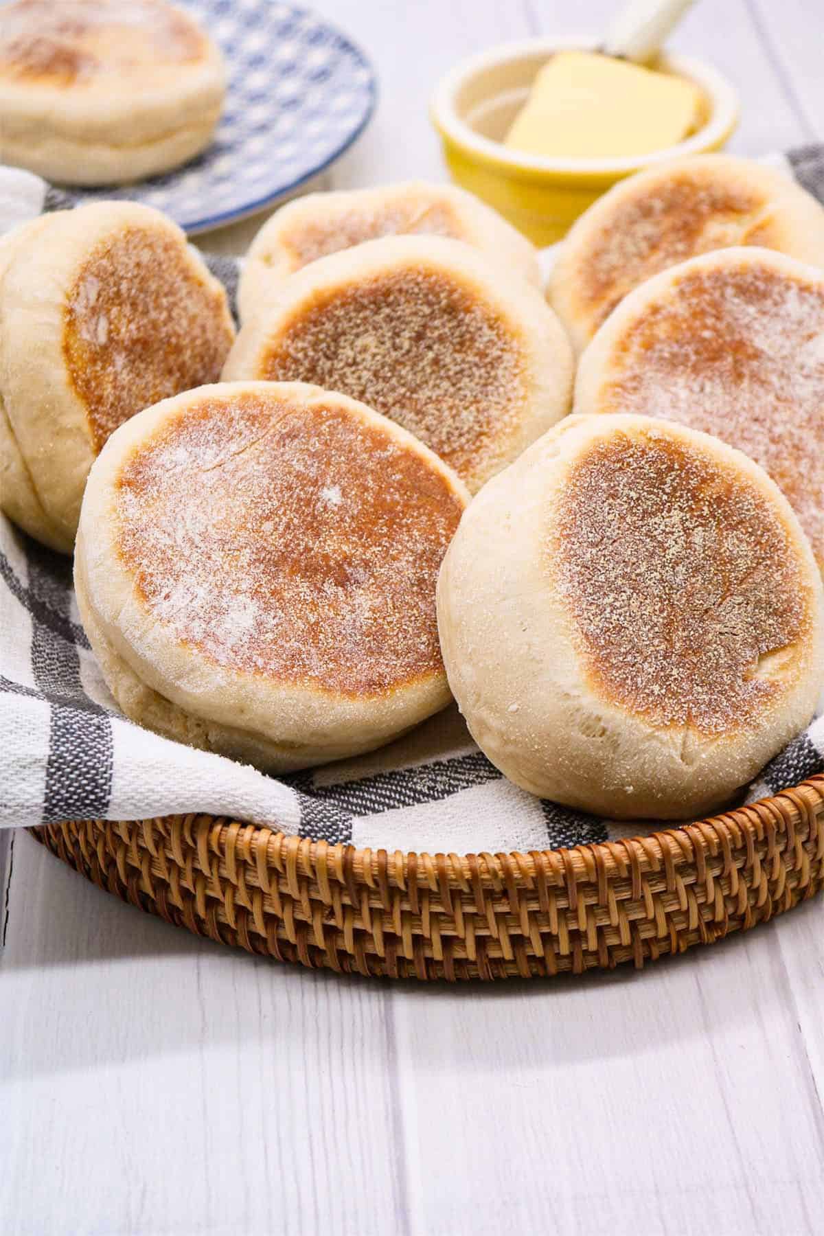 English muffins on black and white towel in bread basket
