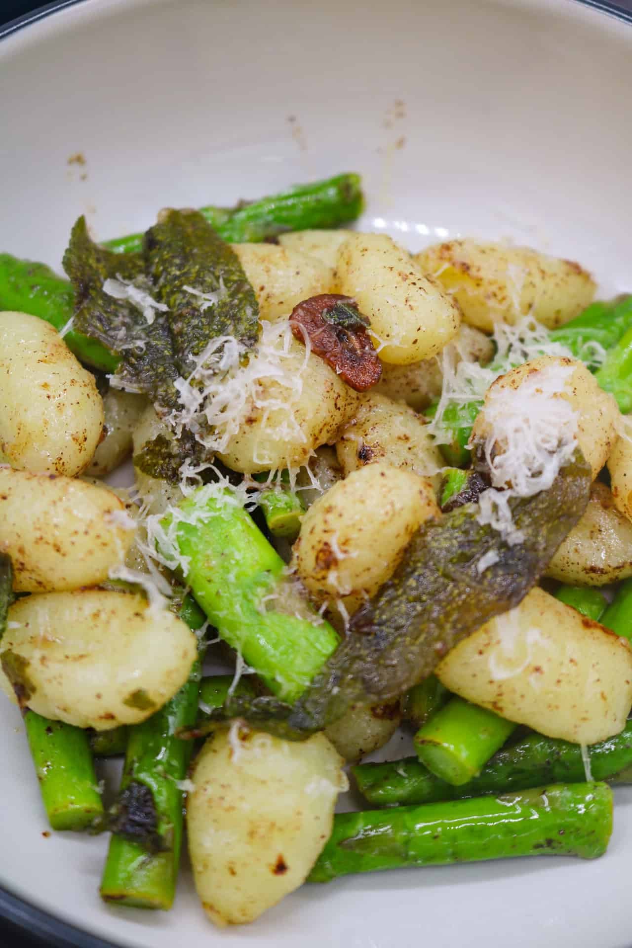 Gnocchi with asparagus, sage and lemon butter in bowls