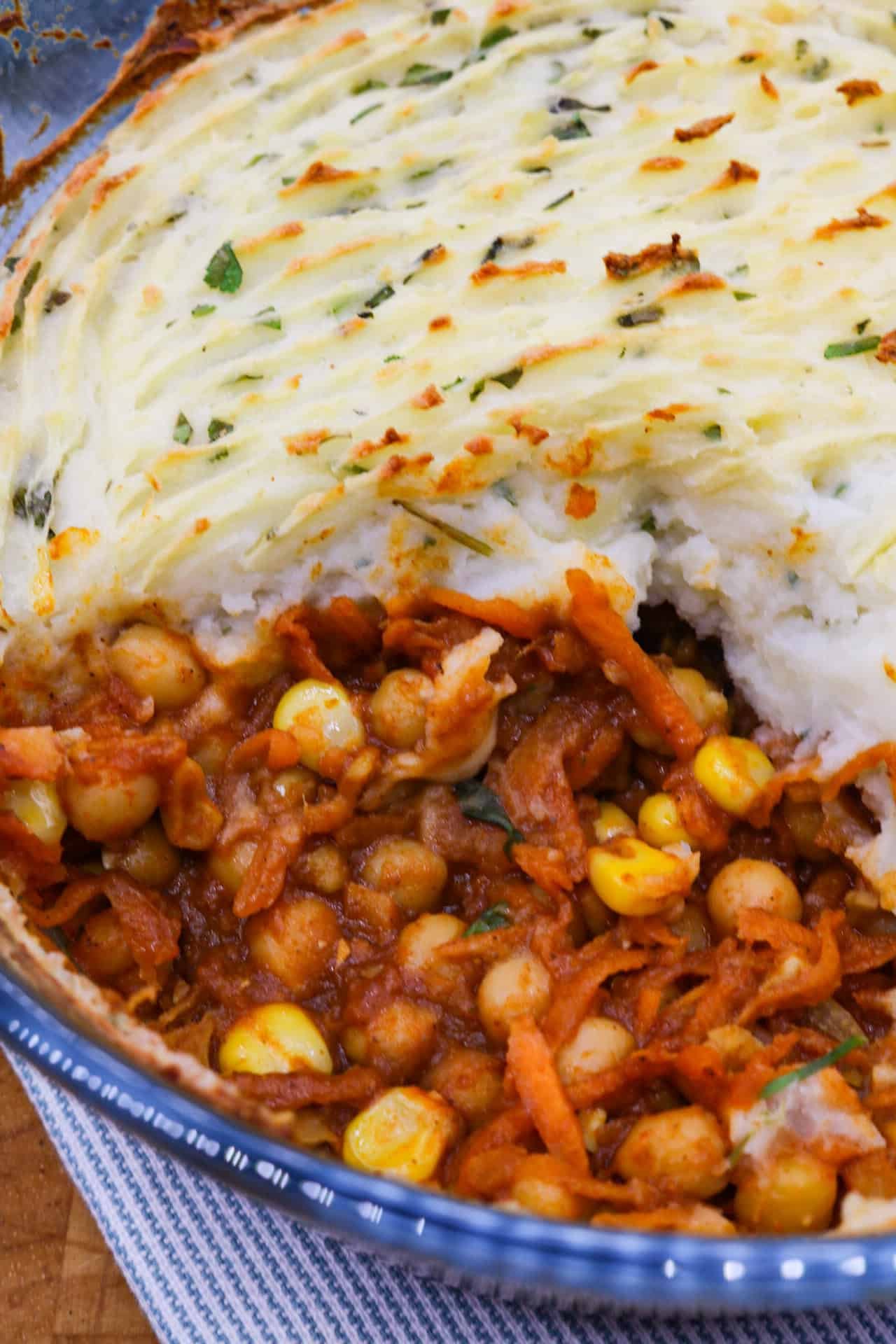 Close up of a spicy veggie pie in a clear round oven dish.