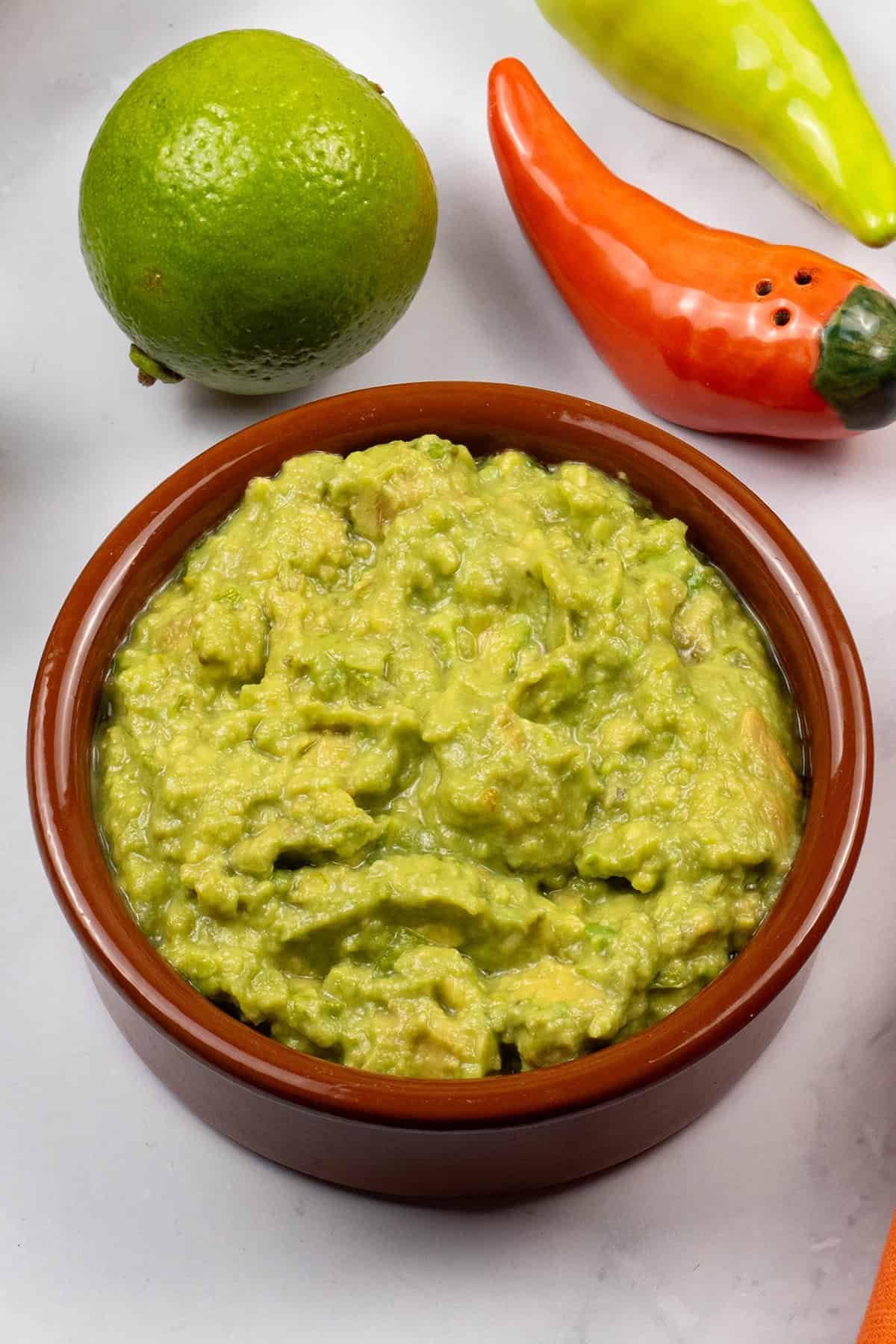 Guacamole in a terracotta serving dish.