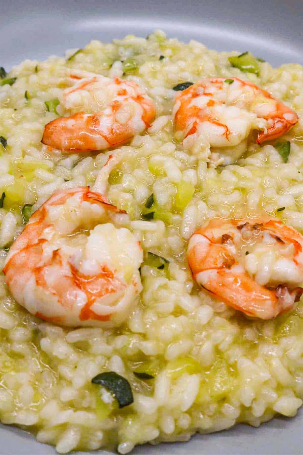 close up of prawn and courgette risotto in grey bowl