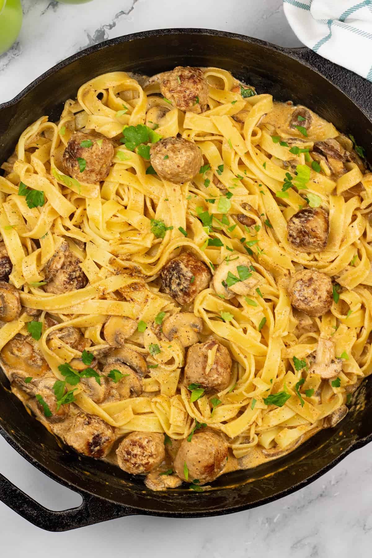 Speedy sausage stroganoff tagliatelle in a skillet.
