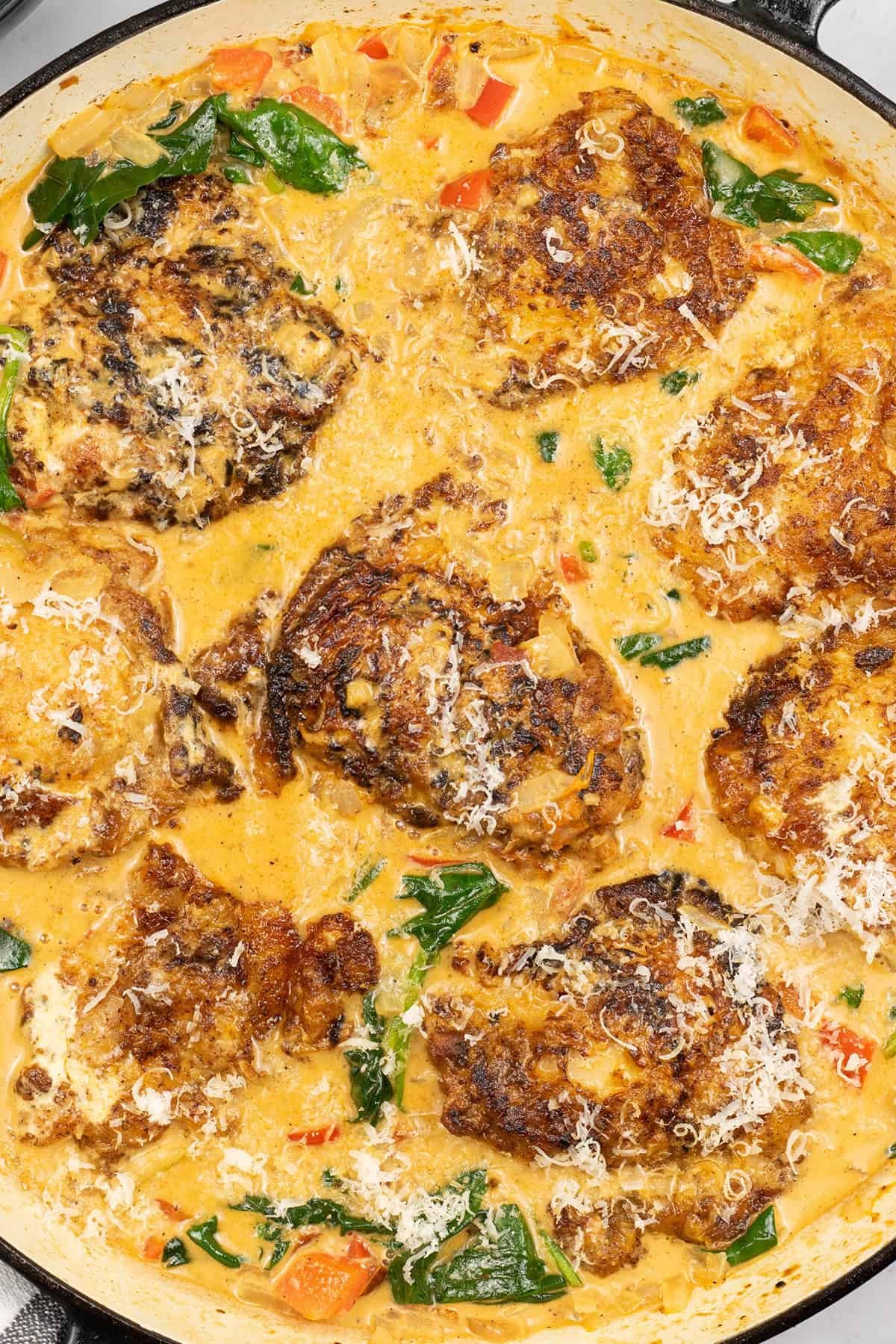 Close up of tuscan chicken in large round casserole dish.