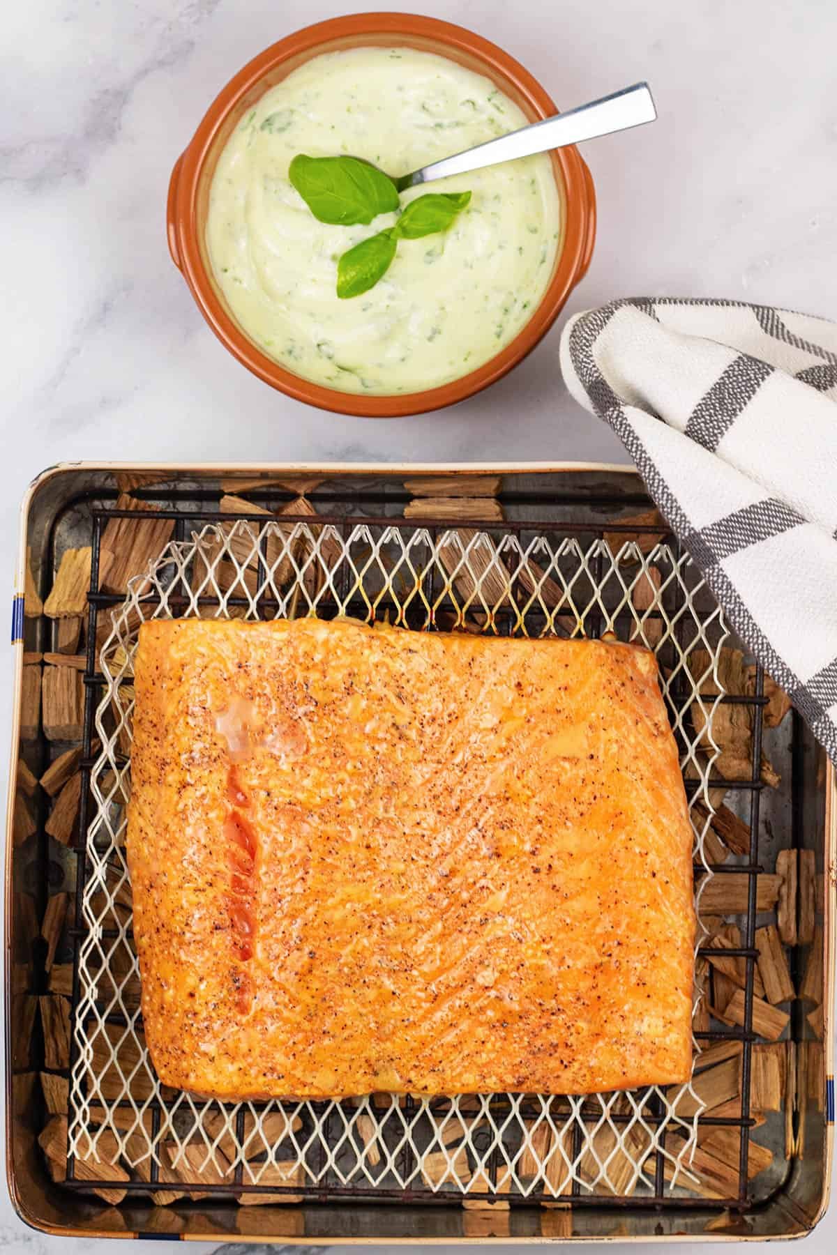 Cooked half side of smoked salmon in a biscuit tin, with dish of basil mayo on the side.