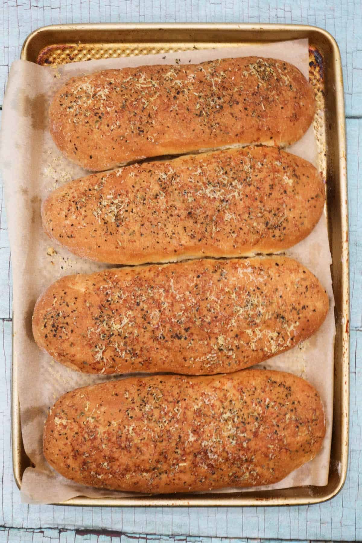 Italian herb sub rolls on baking tray