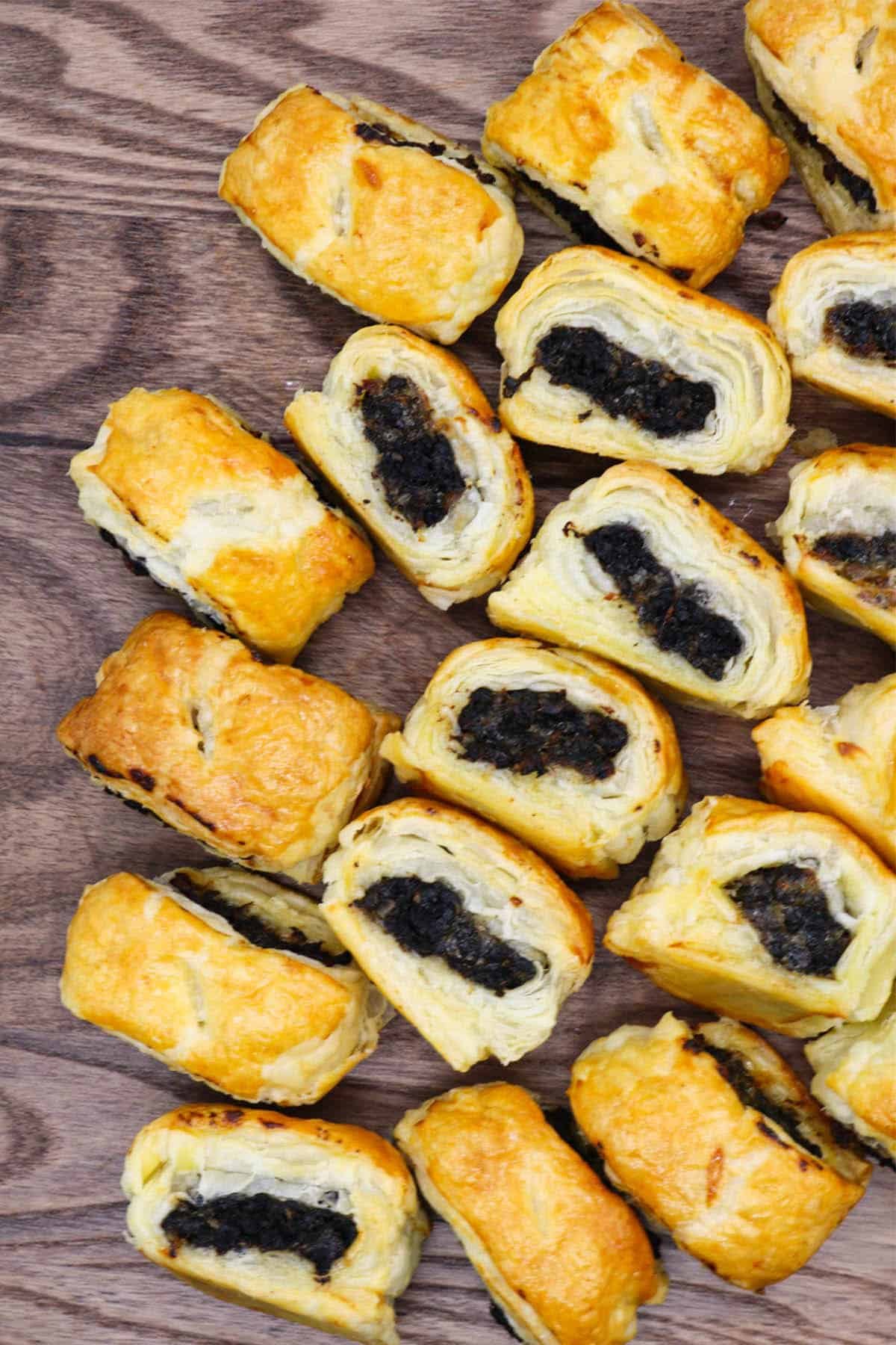 Pork and black pudding sausage rolls on wooden board