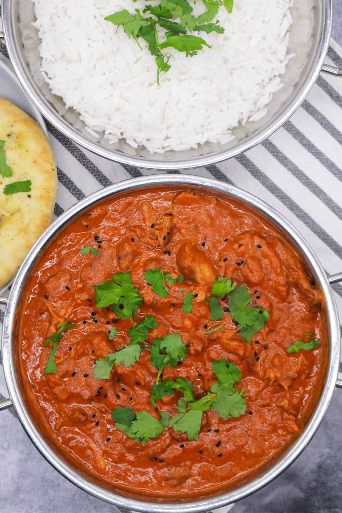 Slow cooker chicken tikka masala in balti dish with coriander and nigella seeds