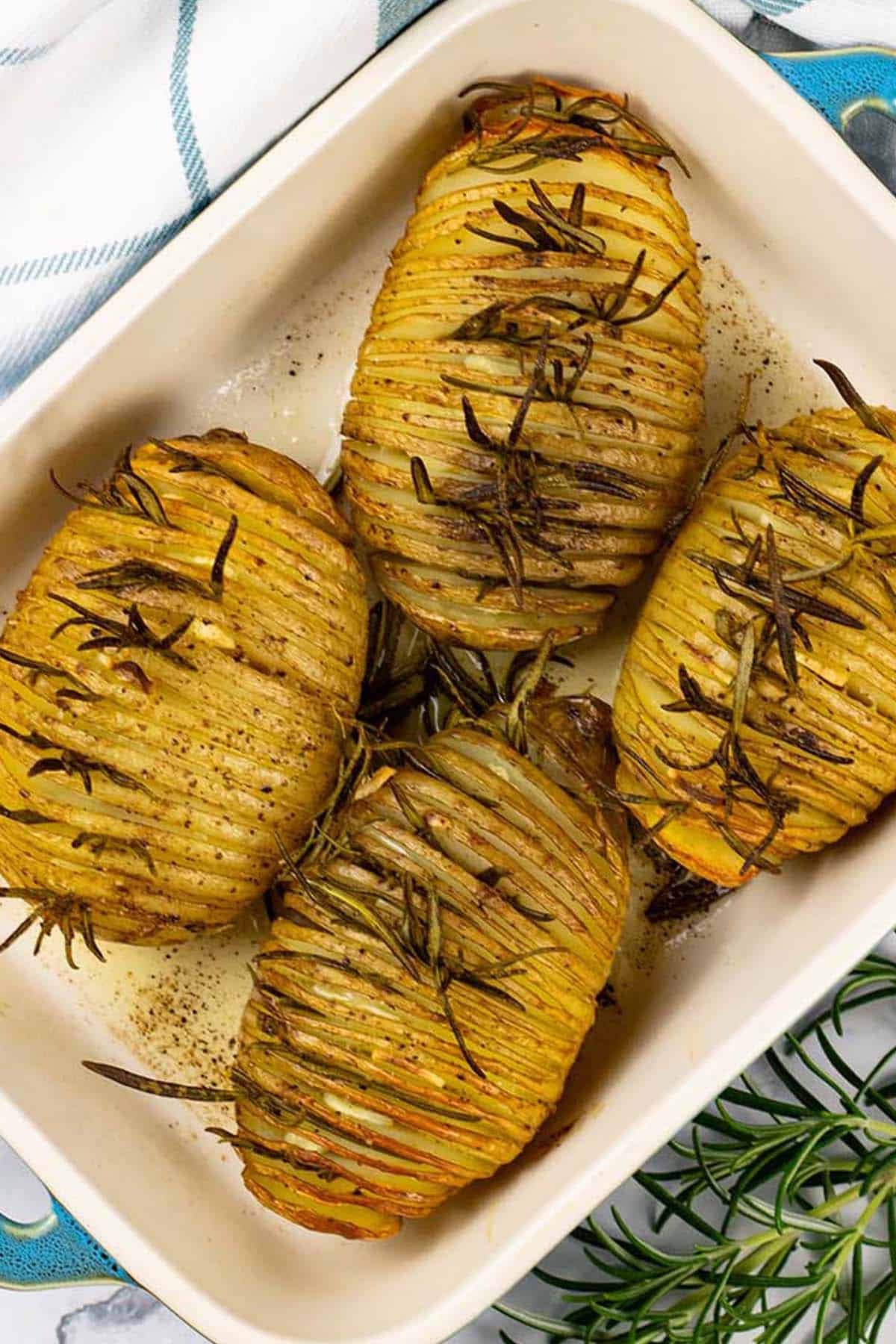 4 garlic and rosemary hasselback potatoes in a Staub ovenproof dish.
