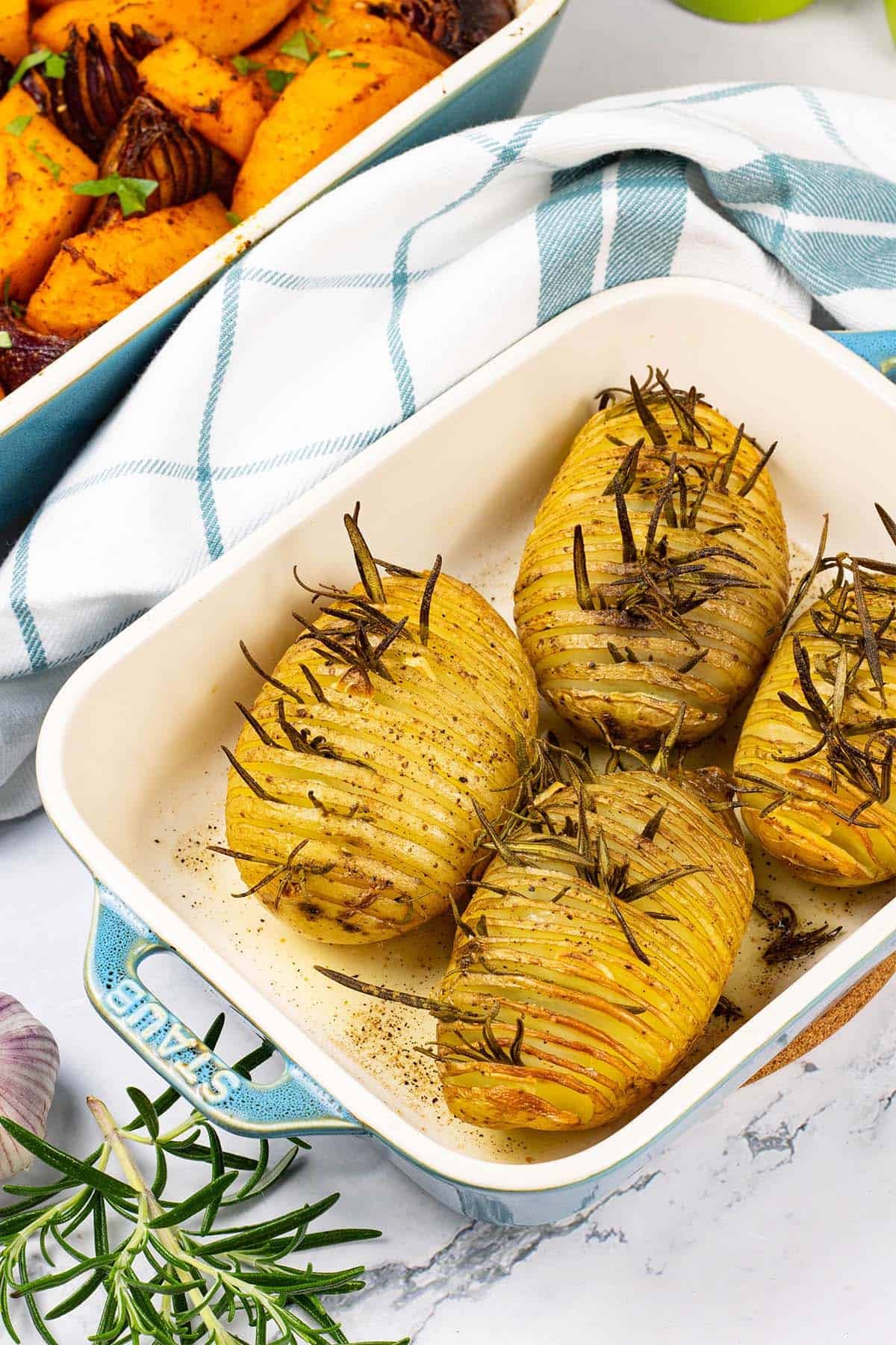 4 garlic and rosemary hasselback potatoes in a Staub ovenproof dish.