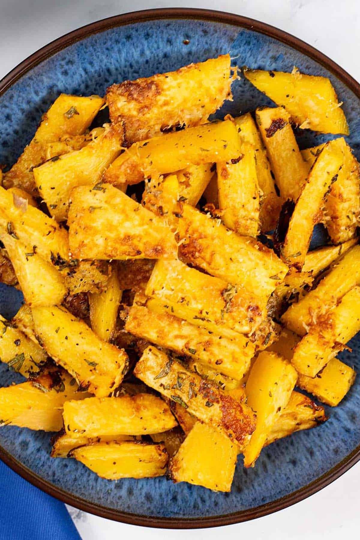 Parmesan and rosemary swede in a blue patterned serving bowl.