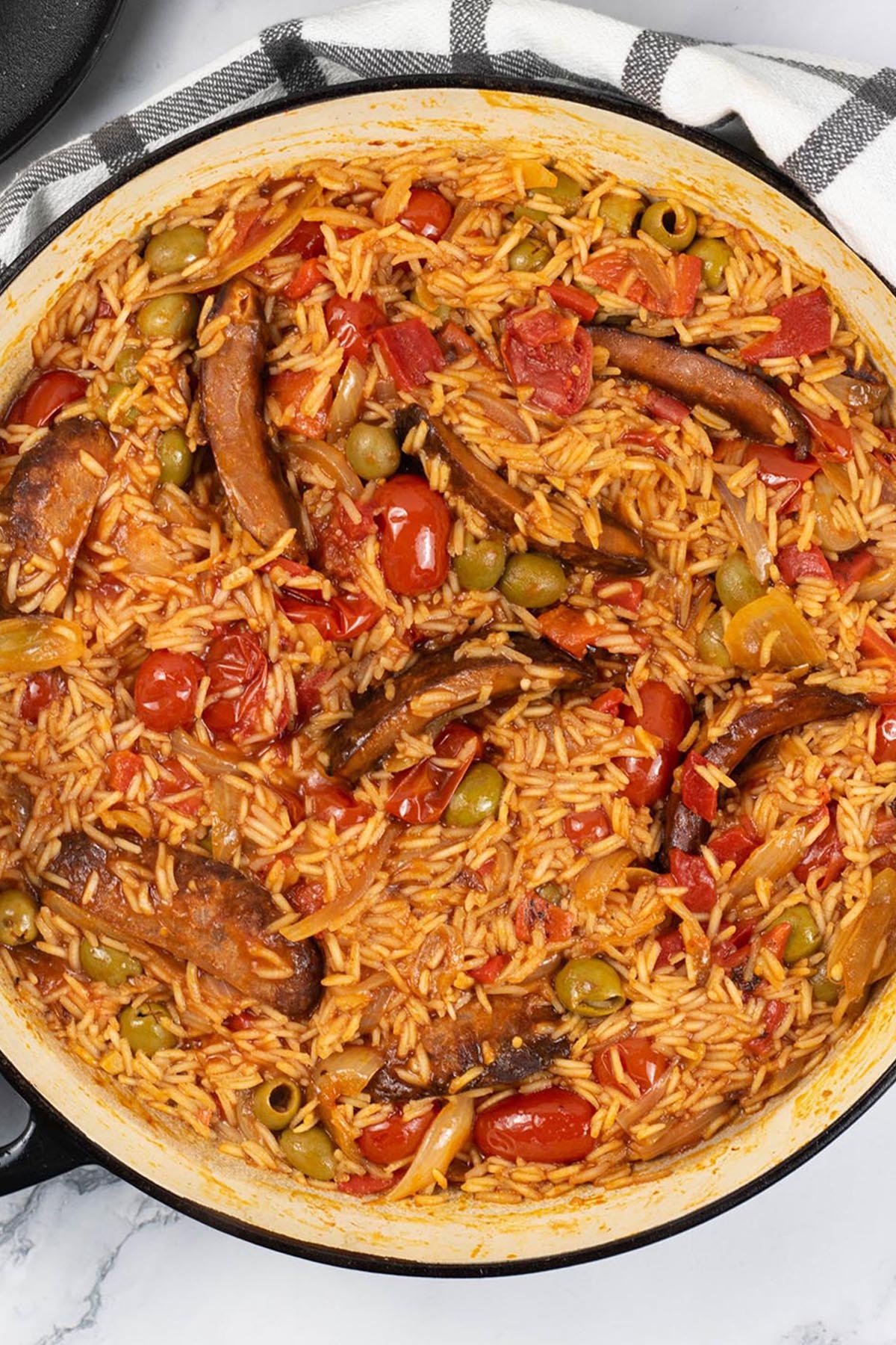Tomato and chorizo rice in a large shallow round casserole.