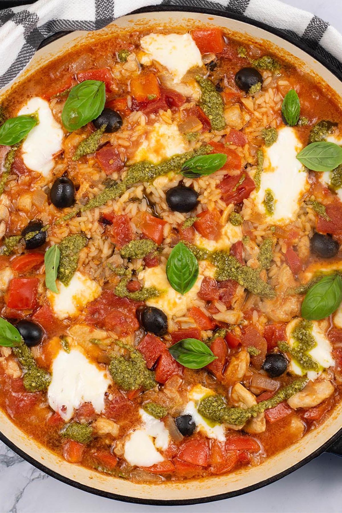 Chicken rice with tomato, basil and mozzarella in a large round casserole.