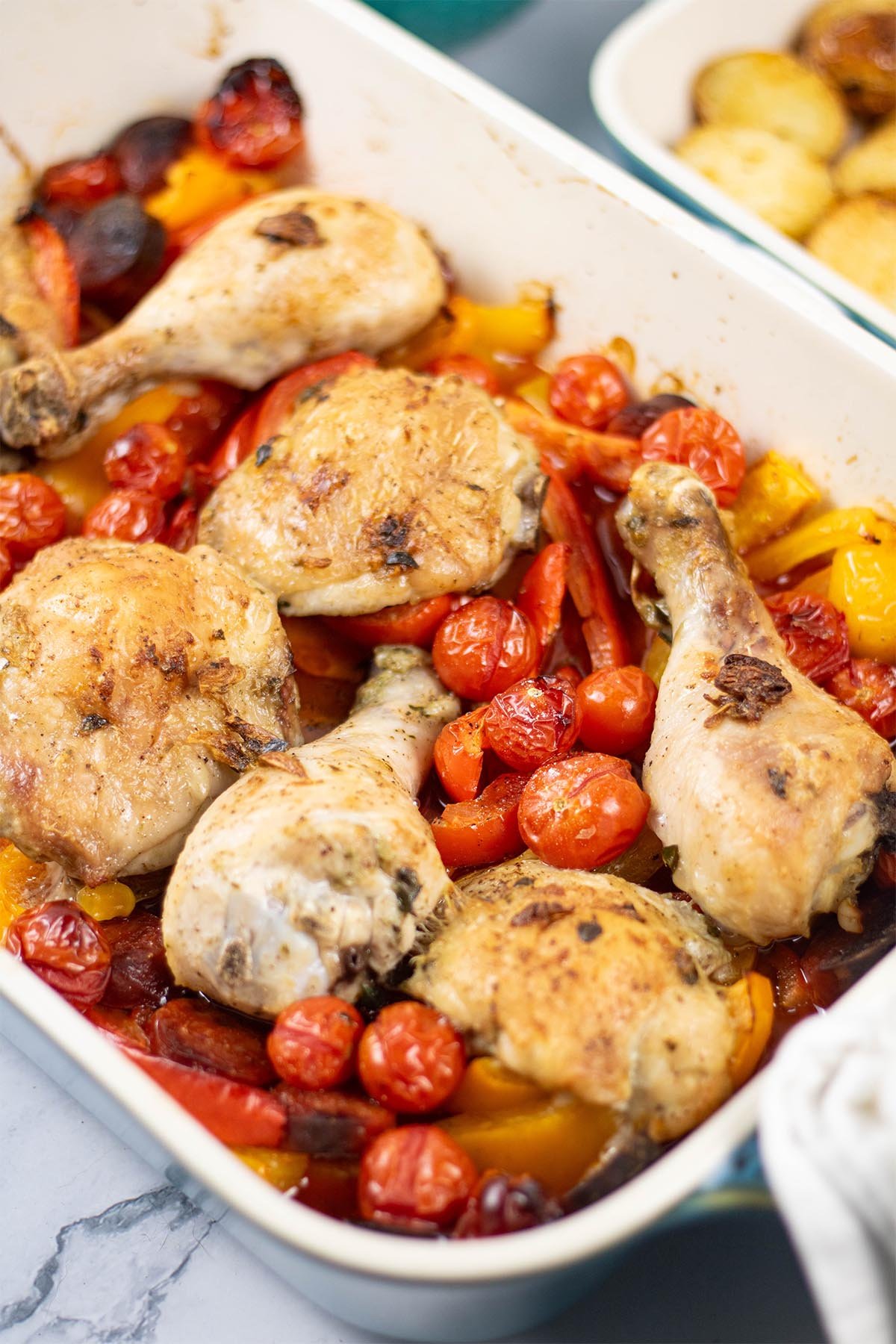 Spanish chicken tray bake in a large rectangle Staub oven dish.