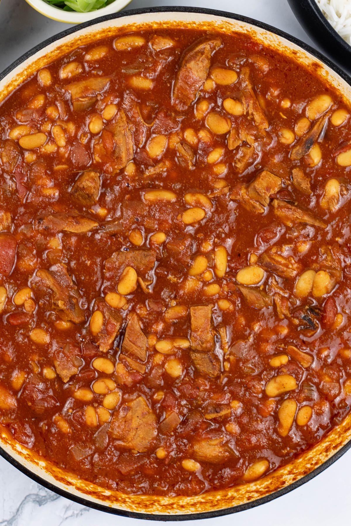 Slow cooked pork shoulder chilli in a large round casserole.
