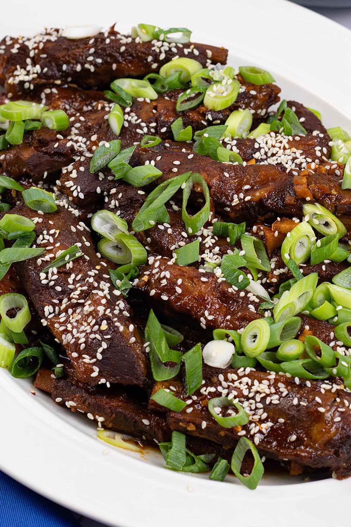 Slow cooker gochujang pork ribs on an oval white platter.
