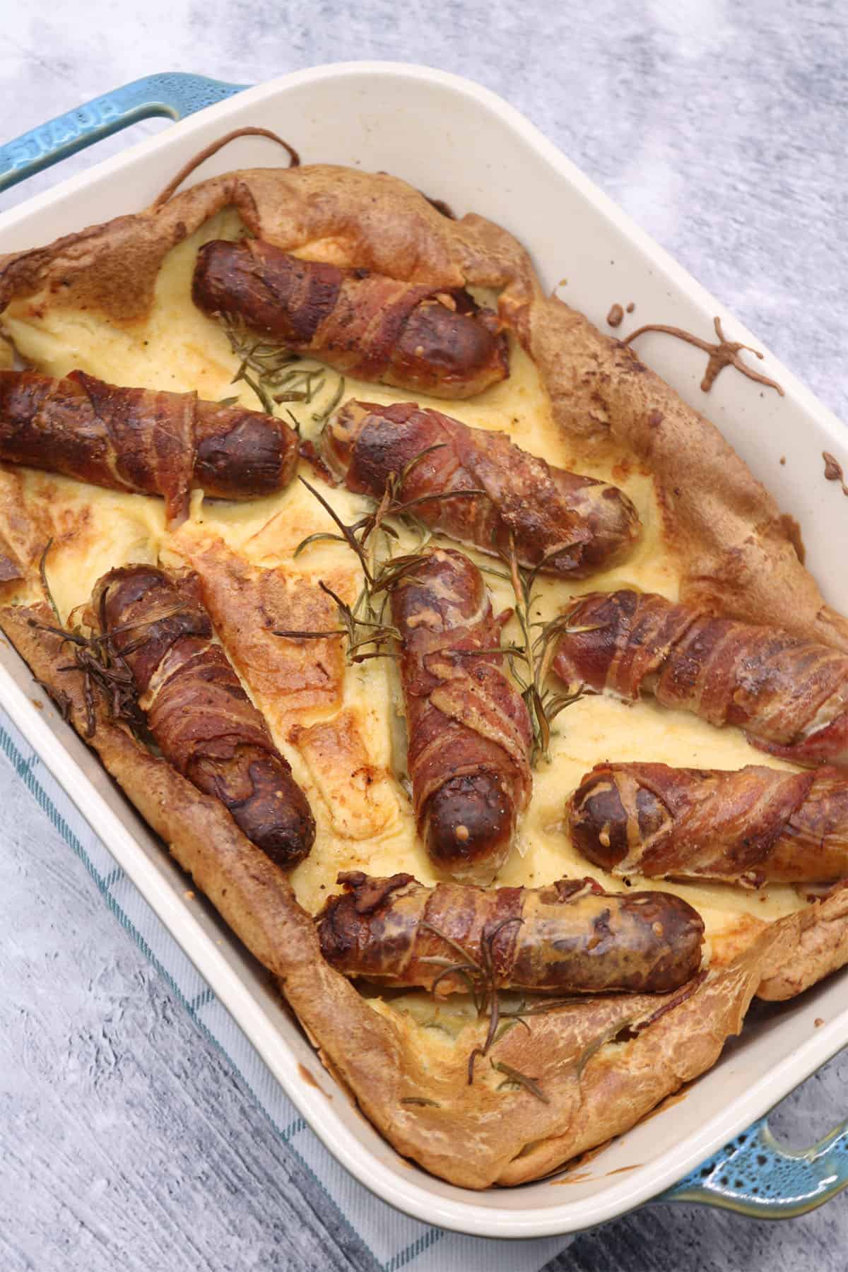 Herb and mustard toad in the hole in rectangle oven dish