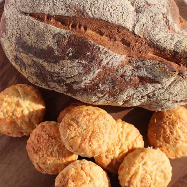 large crusty bread and chilli cheese scones on wooded board
