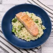 Salmon and spring vegetable risotto in blue bowl