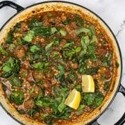 Lamb meatball and giant couscous stew in large round casserole dish.