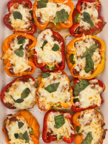 Bolognese stuffed peppers in large Staub rectangle oven dish.
