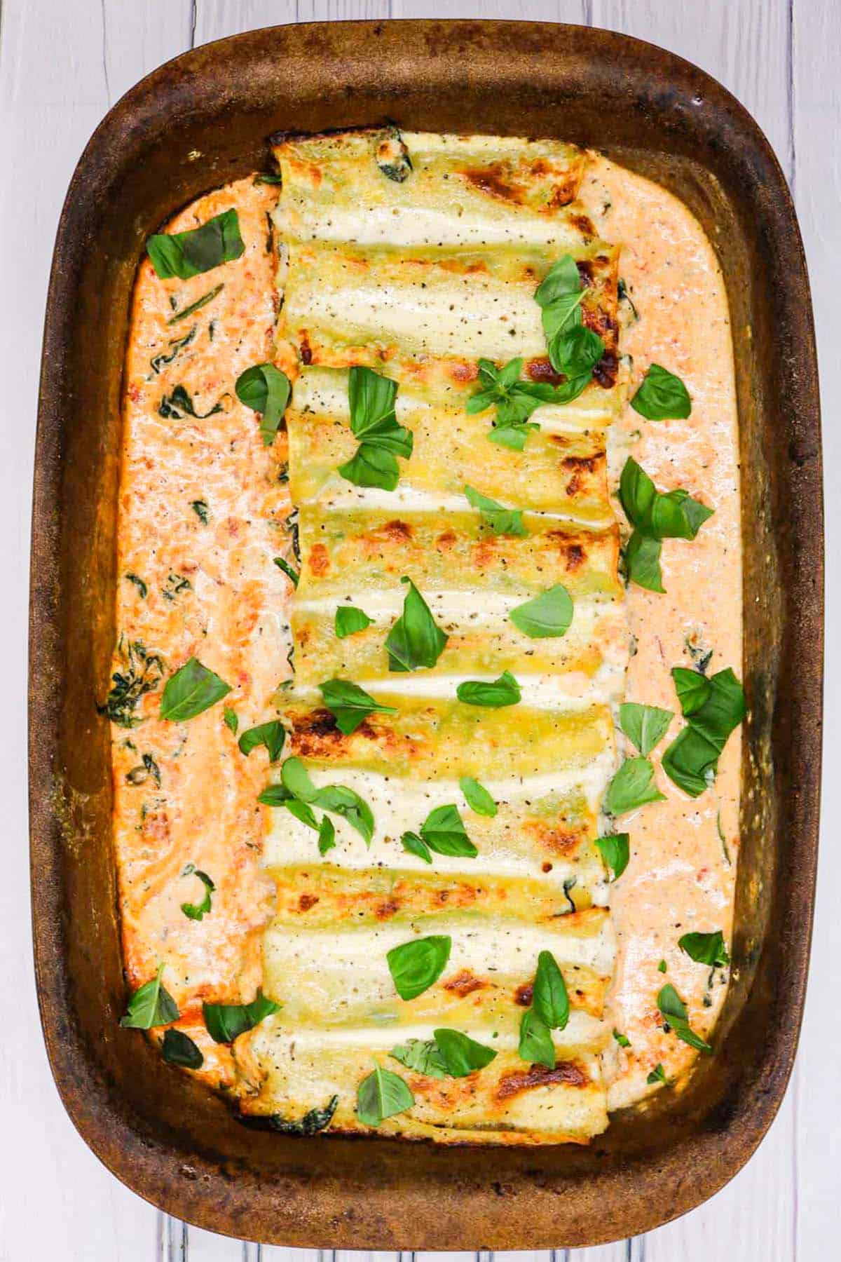 Chicken, spinach and ricotta cannelloni in a large ovenproof dish.