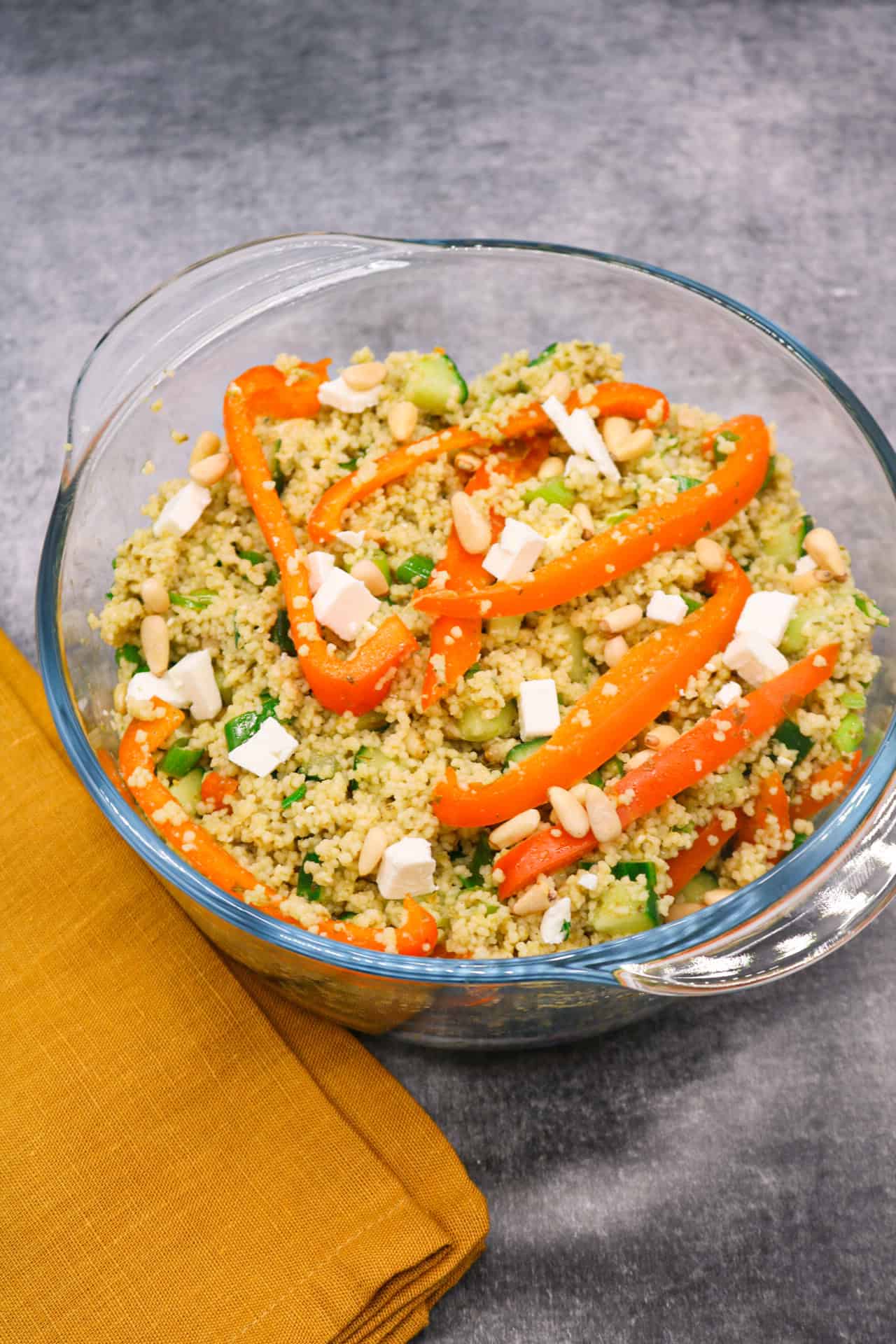 Couscous salad with feta in clear bowl
