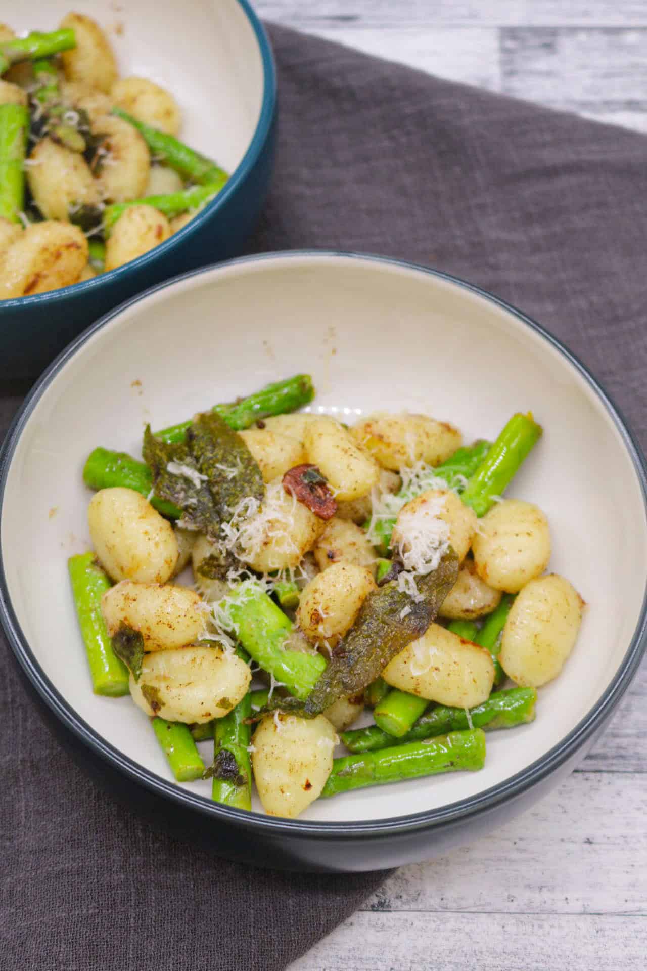 Gnocchi with asparagus, sage and lemon butter in bowls