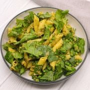 Pesto, peas and spinach pasta salad in large bowl