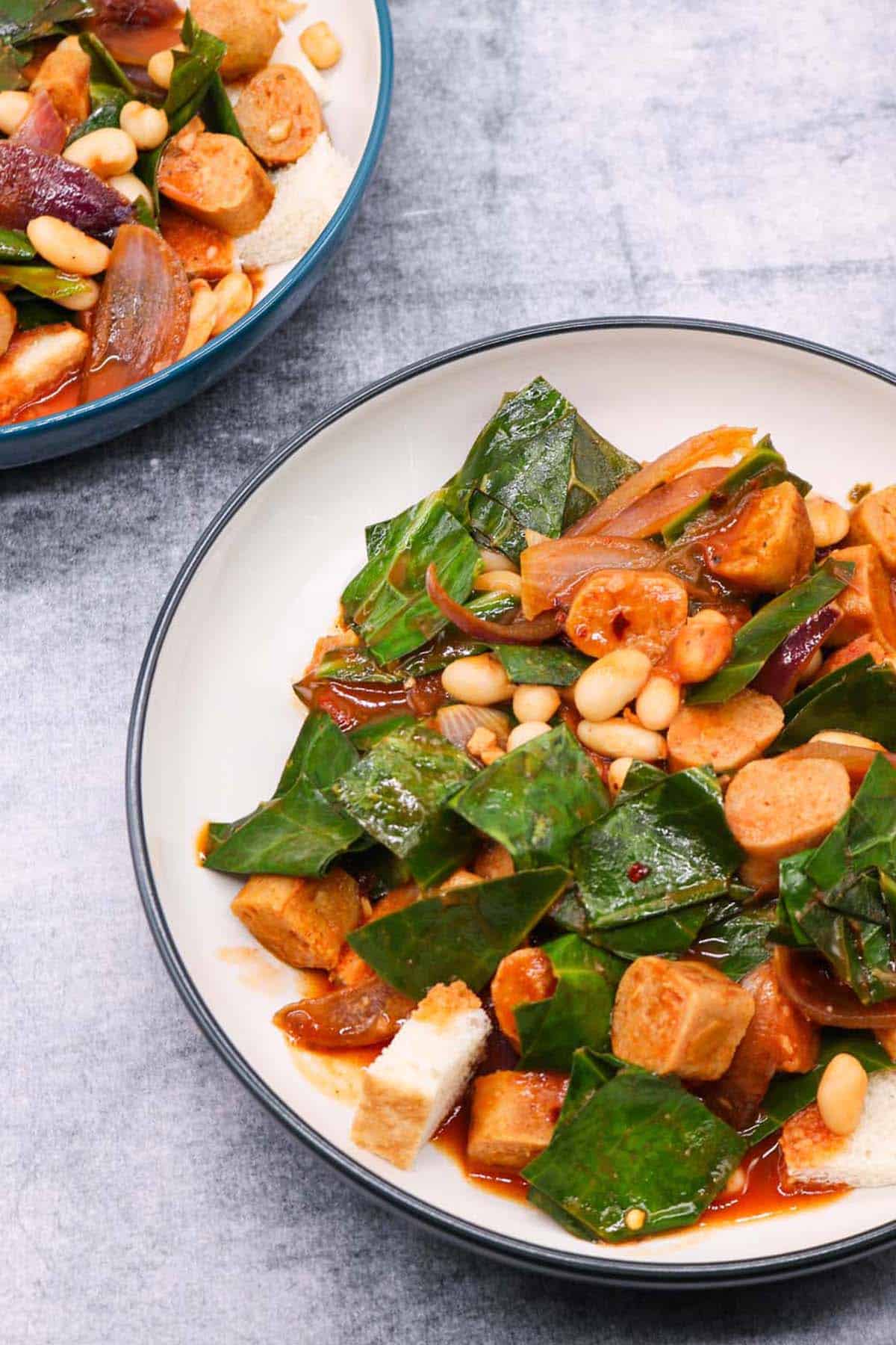 Two bowls of vegan sausage and white bean stew.