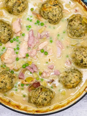 Chicken and gammon stew with buttermilk dumplings in a large round casserole.