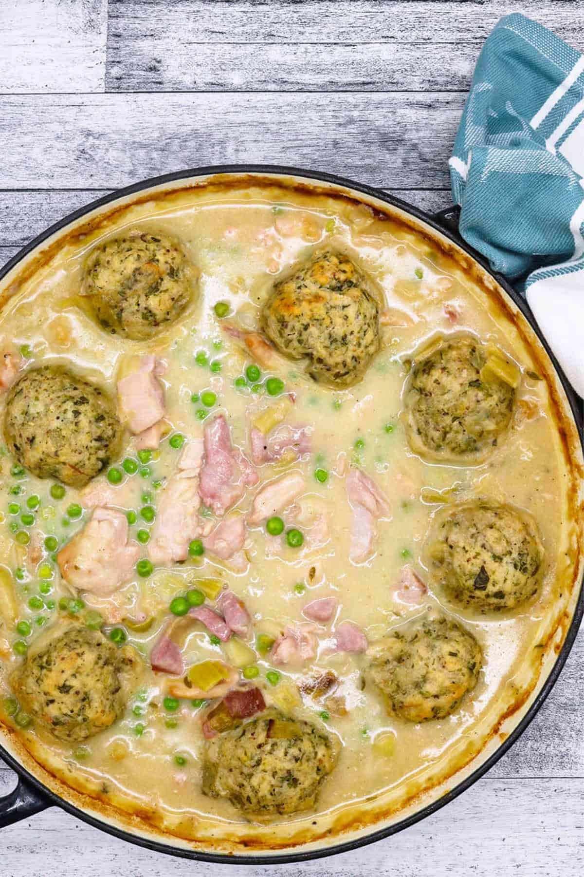 Chicken and gammon stew with buttermilk dumplings in a large round casserole.