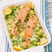 Salmon and gnocchi in rectangle serving dish with lemon wedges