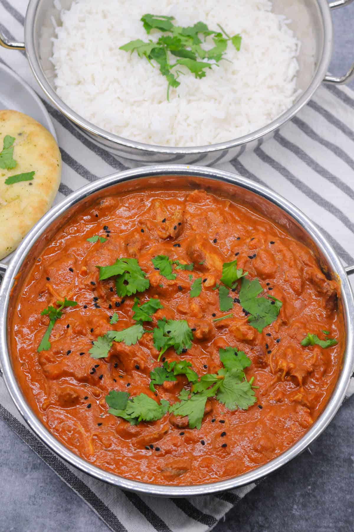 Slow cooker chicken tikka masala in balti dish with coriander and nigella seeds