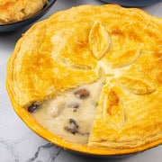 Creamy chicken and mushroom pie in a yellow pie dish.