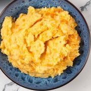 Root veg mash in a blue patterned serving bowl.