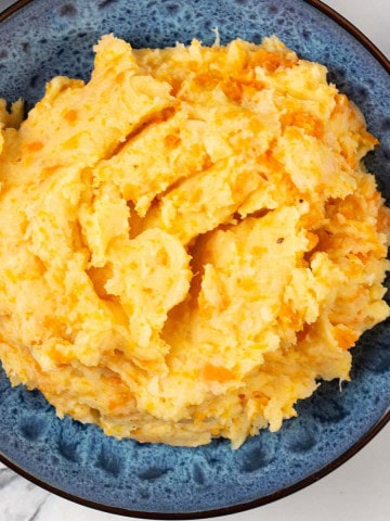 Root veg mash in a blue patterned serving bowl.
