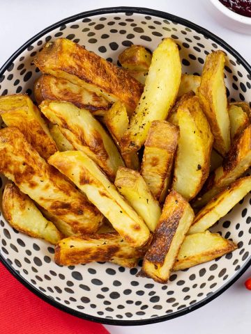 Chunky oven chips in a small serving bowl.