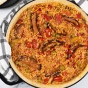 Tomato and chorizo rice in a large shallow round casserole.