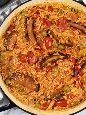 Tomato and chorizo rice in a large shallow round casserole.