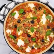 Chicken rice with tomato, basil and mozzarella in a large round casserole.
