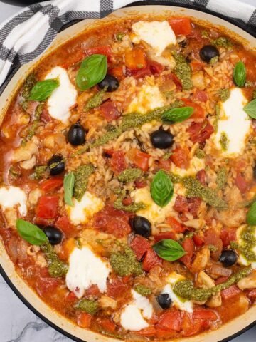 Chicken rice with tomato, basil and mozzarella in a large round casserole.