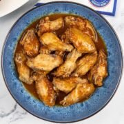 Easy air fryer piri piri chicken wings in a blue patterned serving bowl.
