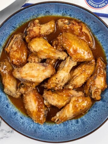 Easy air fryer piri piri chicken wings in a blue patterned serving bowl.