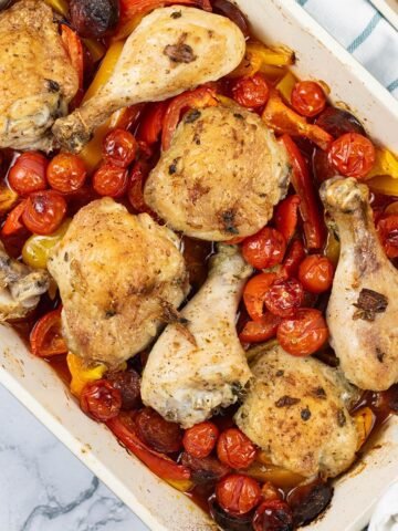 Spanish chicken tray bake in a large rectangle Staub oven dish.