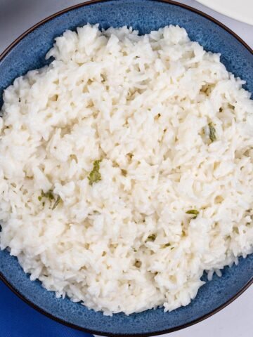 Coconut rice in a blue patterned serving bowl.